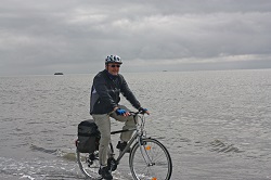 Radfahrer fährt am Meer entlang